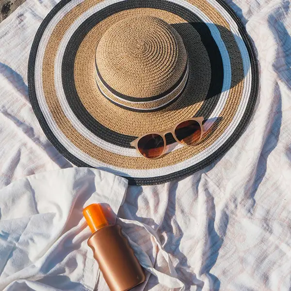 A hat, sunglasses, and sunscreen
